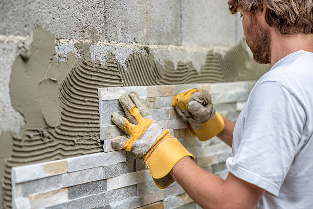 Man putting ornamental tile on a wall | Safety Training Academy